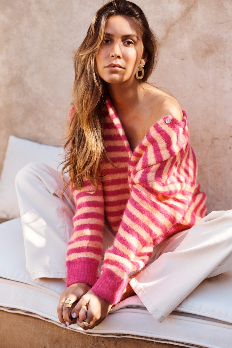 Gilet Camille Sahoma rayée rose en maille et boutonné, manches longues, portée avec un jean