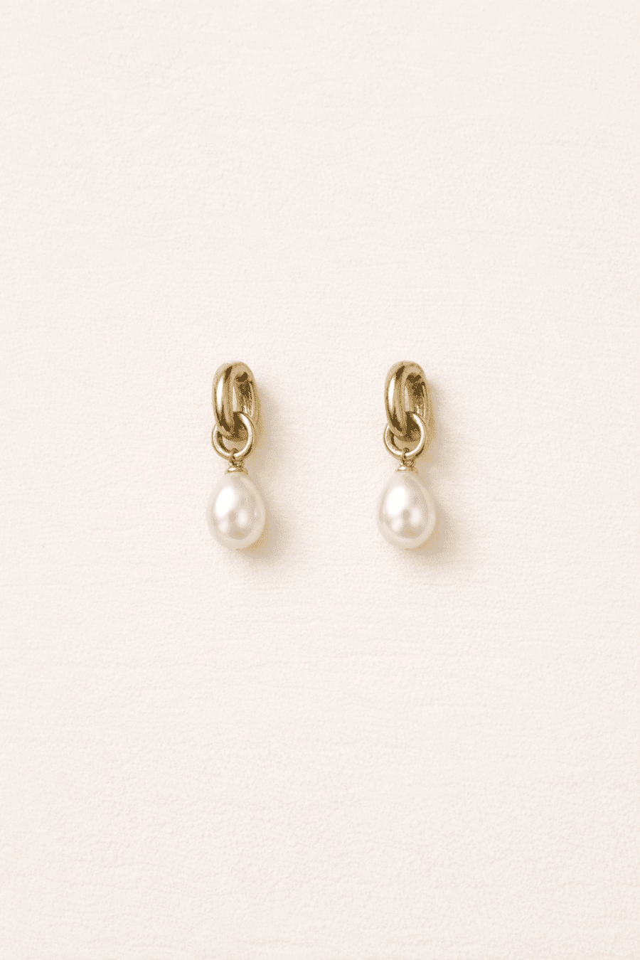 Boucles d’oreilles Cisne dorées et blanches Sahoma, perle effet nacré pendante, sur fond blanc